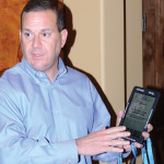 Mike Feigin demonstrates the Technology Educational Device to MainStreet visitors. 