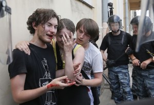 Riot police guard gay rights activists who have been beaten by anti-gay protesters during an authorized gay rights rally in St.Petersburg, Russia. Police detained several gay activists, who were outnumbered by the protesters. Dozens of gay activists had to be protected by police as they gathered for the parade, which proceeded with official approval despite recently passed legislation targeting gays. Photo: AP Photo/Dmitry Lovetsky