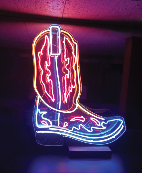 The boot at the bar: Neon Boots’s neon boot shows off its bright colors. Right: Neon Boots in the middle of construction gives an idea of the size of the new bar—and this is just one area of the building.