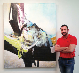 Ryan Fugate with his piece "Breaking the Wave (48 x 60)," recently acquired by Chevron Corp.