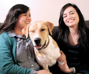 Yvonne Marquez (l) and Gloria Delgadillo (r) snuggle up to their ten-month-old Lab/Pitbull mix, Tungi (which means “victory” in the Nigerian language of Yoruba). He is an adventurous pup that loves taking long walks around the neighborhood, giving people hugs, and destroying all his rope toys. The couple describes Tungi as “the Ryan Gosling of dogs.”