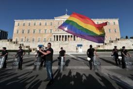 A gay pride protester waves a rainbow flag in front of the Greek parliament in central Athens.  Photo: AFP/File, Aris Messinis