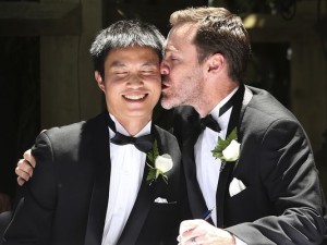 Ivan Hinton, right, gives his partner Chris Teoh a kiss after taking their wedding vows during a ceremony at Old Parliament House in Canberra, Australia. Photo: Rob Griffith/AP